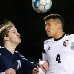 Arlington's Jack Machovina watches Monroe's Rafael Garnica heads the ball Friday evening at Arlington High School in Arlington, Washington on March 18, 2022. (Kevin Clark / The Herald)