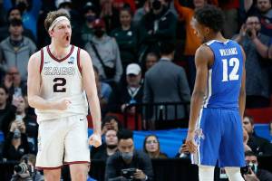 Gonzaga forward Drew Timme (2) reacts next to Memphis forward DeAndre Williams (12) at the end of a second-round NCAA college basketball tournament game, Saturday, March 19, 2022, in Portland, Ore. Gonzaga won 82-78. (AP Photo/Craig Mitchelldyer)