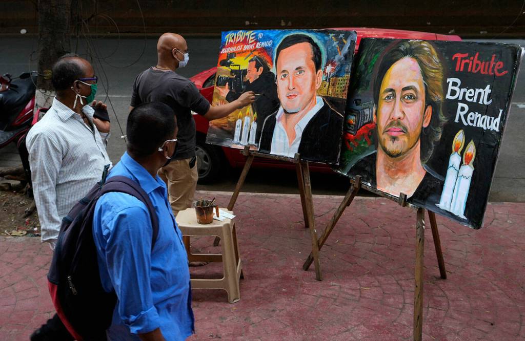 Indian art teacher Sagar Kambli paints a tribute, in Mumbai, India, March 14, to documentary filmmaker Brent Renaud, who was killed after Russian forces opened fire on his vehicle in Ukraine. (Rajanish Kakade / Associated Press)