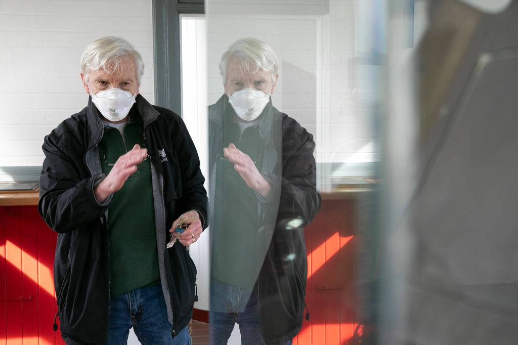 Peter Anderson explains the history of the Mukilteo Lighthouses old lens, which is on display on the first floor of the lighthouse. (Ryan Berry / The Herald)
