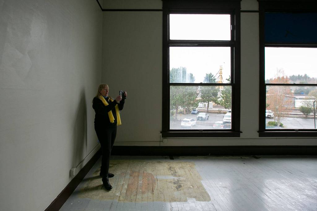 Monroe Historical Society board member Valeria Rae takes photos of the old library at the historical societys downtown building. (Ryan Berry / The Herald)