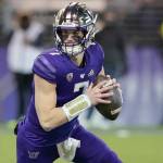 Washington quarterback Sam Huard rolls out game against Washington State on Nov. 26, 2021, in Seattle. (AP Photo/Ted S. Warren)