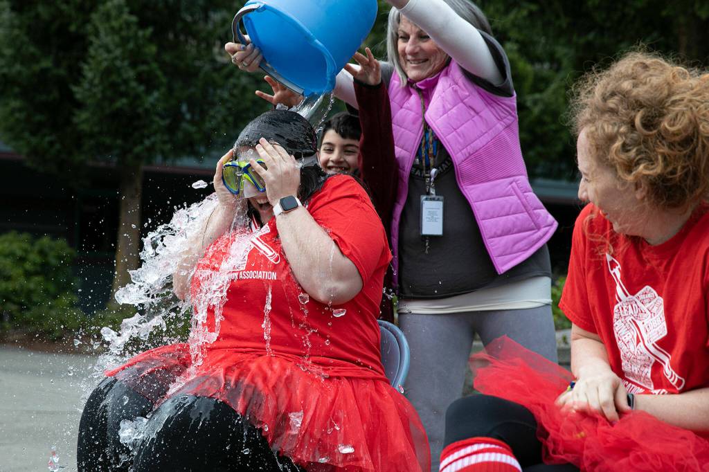 Fourth grade teacher Ailady Avila becomes the first of five teachers to get water dumped on her head. (Ryan Berry / The Herald)