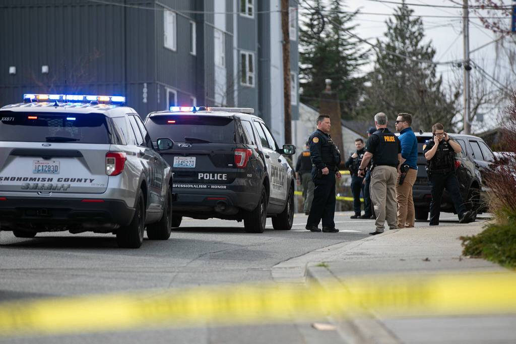 Law enforcement from multiple agencies work near the Starbucks at 1010 N. Broadway, where an Everett police officer was shot and killed Friday afternoon. (Ryan Berry / The Herald)
