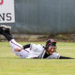 Snohomishs Nickolas Sakamoto dives for the ball in center field against Arlington Friday afternoon at Snohomish High School. The Eagles won 4-2. (Kevin Clark / The Herald)