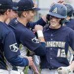 Arlington's Cooper McBride (12) is celebrated for his two-run home run in the 7th inning against Snohomish Friday afternoon at Snohomish High School in Snohomish, Washington on March 25, 2022. The Eagles won 4-2. (Kevin Clark / The Herald)