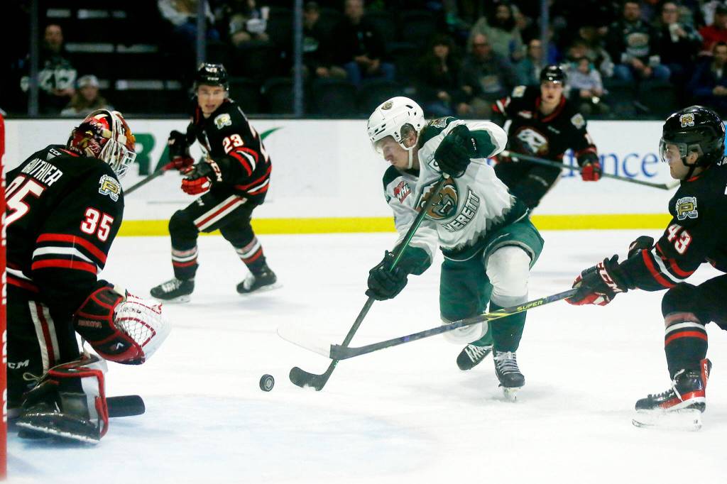 The Everett Silvertips Jackson Berezowski scores his first goal of the night against the Portland Winterhawks Saturday, March 26, 2022, at Angel of the Winds Arena in Everett, Washington. (Ryan Berry / The Herald)