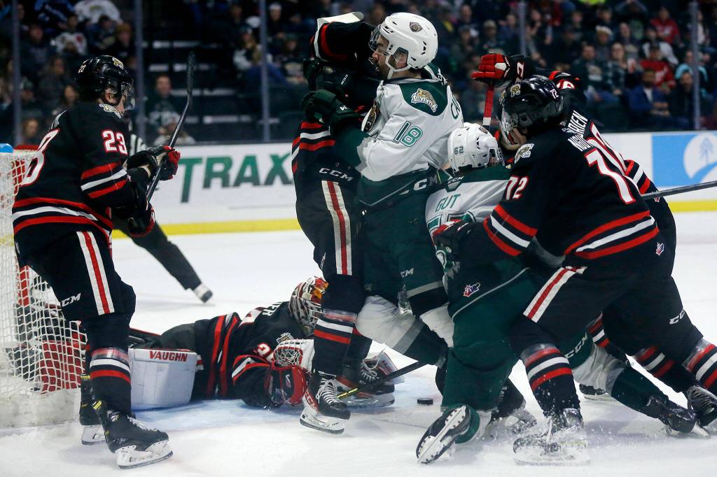 Players scramble in front of the net as the puck remains loose during a game between the Everett Silvertips and the Portland Winterhawks Saturday, March 26, 2022, at Angel of the Winds Arena in Everett, Washington. (Ryan Berry / The Herald)