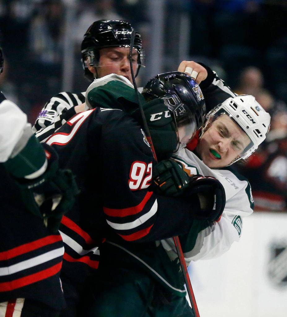 The Everett Silvertips Ty Gibson roughs up an opponent against the Portland Winterhawks Saturday, March 26, 2022, at Angel of the Winds Arena in Everett, Washington. (Ryan Berry / The Herald)