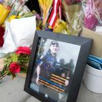 An image of Everett Police Officer Dan Rocha is displayed at his memorial Saturday in Everett. (Ryan Berry / The Herald)