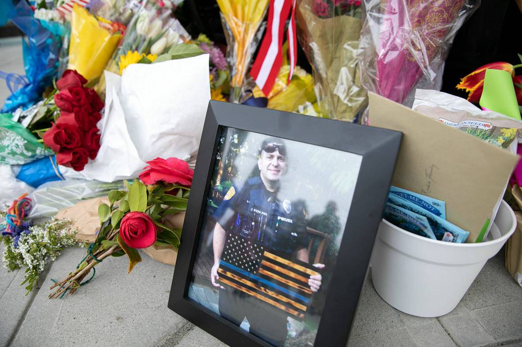An image of Everett Police Officer Dan Rocha is displayed at his memorial Saturday in Everett. (Ryan Berry / The Herald)