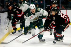 The Everett Silvertips’ Austin Roest draws a tripping penalty behind the net against the Portland Winterhawks Saturday, March 26, 2022, at Angel of the Winds Arena in Everett, Washington. (Ryan Berry / The Herald)