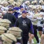 University of Washington coach Kalen Deboer walks among players and staff as they perform early morning warmups during NCAA football practice, Wednesday, March 30, 2022. (Steve Ringman/The Seattle Times via AP)