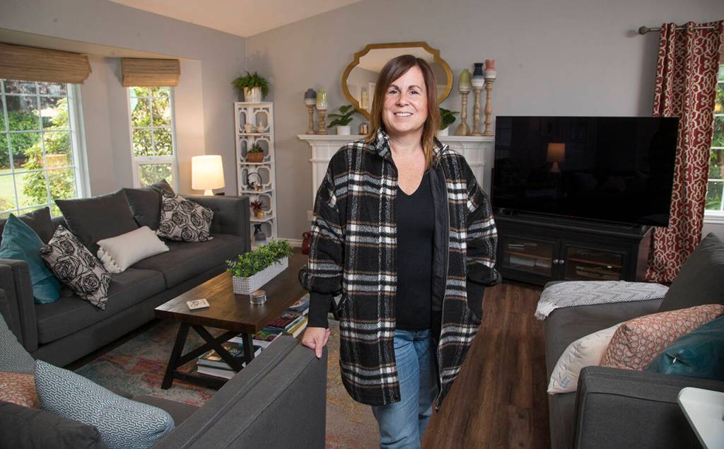 Shelly Henderson stands in her remodeled living room, which was designed by Kelly DuByne. (Andy Bronson)