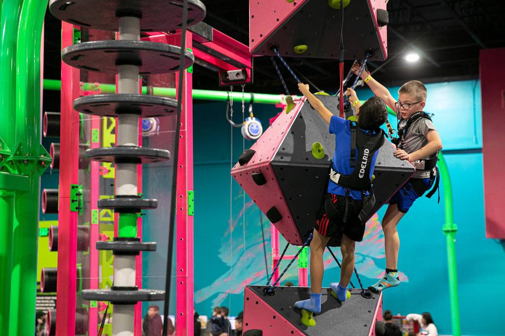 Two children climb at Flying Squirrel trampoline park. (Ryan Berry / The Herald)