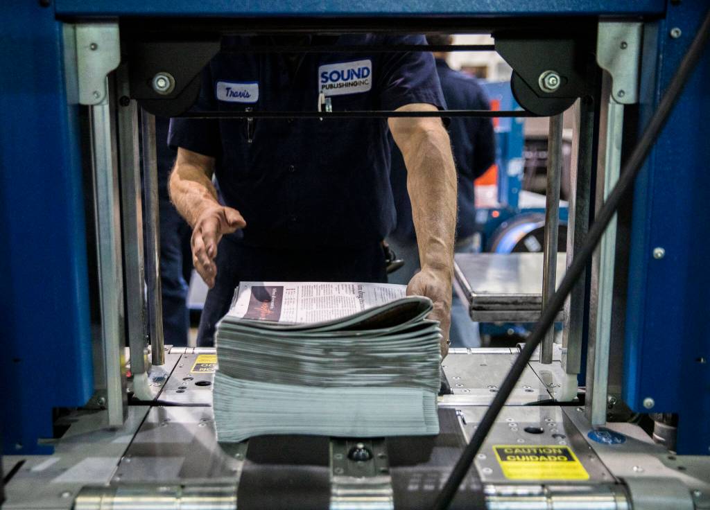 Copies of The Daily Herald are stacked and prepped for delivery at the Paine Field plant in Everett. (Olivia Vanni / The Herald)