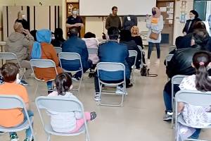 Afghan children and families gather at a resource fair on March 27 in Lynnwood. (Screenshot)