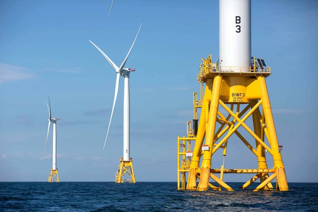 FILE - Three of Deepwater Wind's five turbines stand in the water off Block Island, R.I, the nation's first offshore wind farm on Aug. 15, 2016. As climate change pushes states in the U.S. to dramatically cut their use of fossil fuels, many are coming to the conclusion that solar, wind and other renewable power sources won't be enough to keep the lights on. Nuclear power is emerging as an answer to fill the gap as states transition away from coal, oil and natural gas to reduce greenhouse gas emissions and stave off the worst effects of a warming planet.   (AP Photo/Michael Dwyer, File)