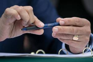 Governor Jay Inslee prepares to sign a number of bills into law during a bill signing Friday, March 25, 2022, outside the ferry terminal in Mukilteo, Washington. (Ryan Berry / The Herald)