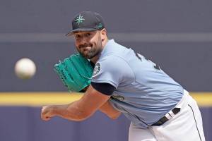 Seattle Mariners starting pitcher Robbie Ray throws during the first inning of a spring training baseball game against the Texas Rangers Monday, March 28, 2022, in Peoria, Ariz. (AP Photo/Charlie Riedel)