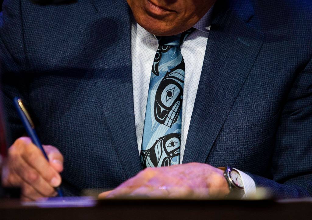 Gov. Jay Inslee signs HB 1725 into law on March 31 in Tulalip. (Olivia Vanni / The Herald)