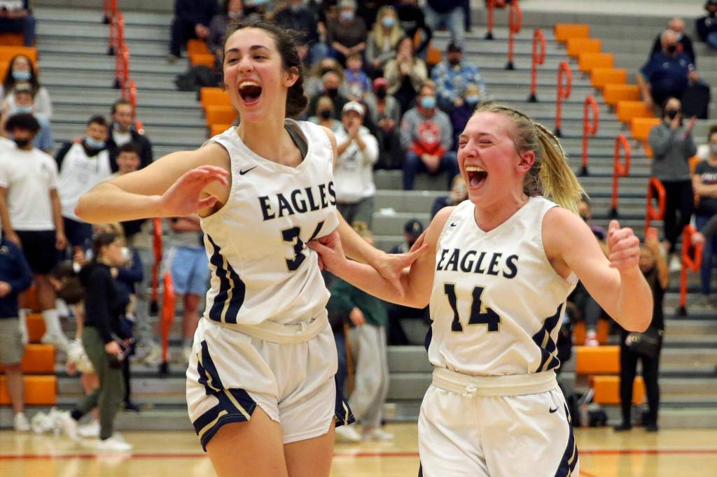 Villa and Keira Marsh celebrate winning the 3A District 1 Tournament title. (Kevin Clark / The Herald )