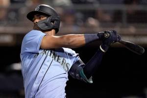 Seattle Mariners' Julio Rodriguez bats during the second inning of a spring training baseball game against the Chicago White Sox Friday, March 25, 2022, in Peoria, Ariz. (AP Photo/Charlie Riedel)
