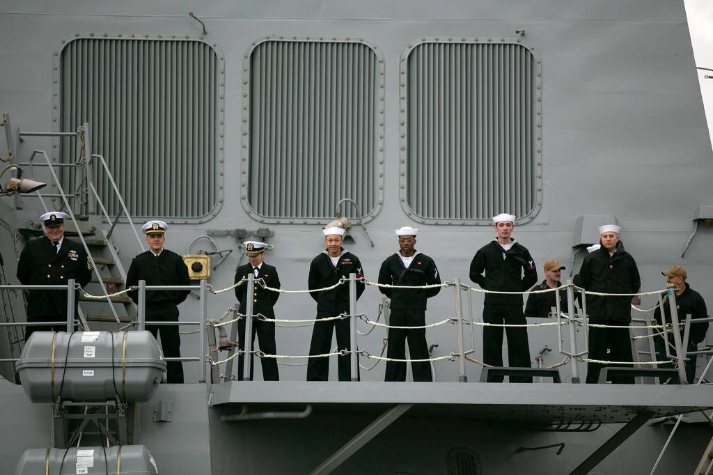 Navy personnel stand aboard the USS McCampbell before disembarking Friday at Naval Station Everett. (Ryan Berry / The Herald)