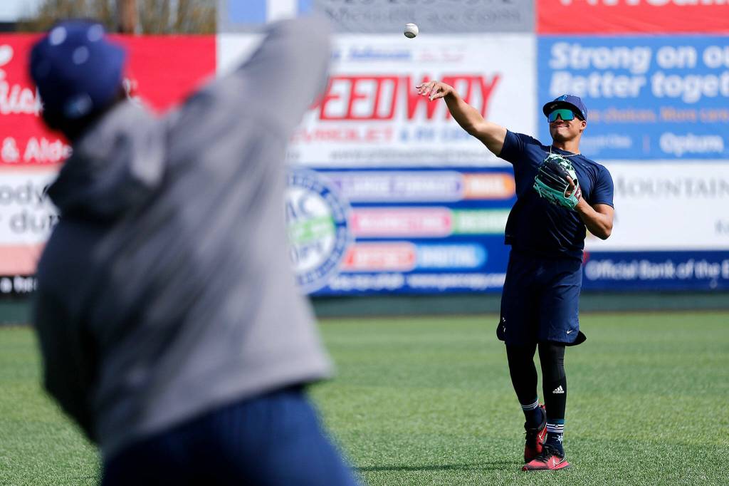 The AquaSoxs Noelvi Marte long-tosses with teammate Alberto Rodriguez. (Ryan Berry / The Herald)