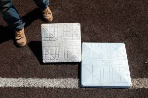 The old 15-inch base, left, compared to the new 18-inch base, right, on Wednesday, April 6, 2022, at Funko Field in Everett, Washington. (Ryan Berry / The Herald)