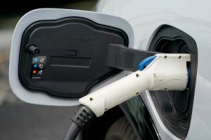 In this photo made on Thursday, May 6, 2021, a 2021 Ford Mustang Mach E is seen as it is charging at a Ford dealer in Wexford, Pa.  Ford is spinning off its electric vehicles and internal combustion businesses into separate units. The automaker said Wednesday, March 2, 2022 that its plan includes two distinct, but strategically interdependent, auto businesses – Ford Blue and Ford Model e.(AP Photo/Keith Srakocic)