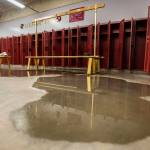 A large puddle of water forms on the floor of the Lakewood field locker rooms on April 12 in Arlington. (Olivia Vanni / The Herald)