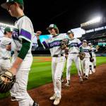 Edmonds-Woodways Grant Oliver smiles while fist-bumping his teammates before the start of the game. (Olivia Vanni / The Herald)