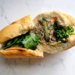 Bánh mì, a traditional Vietnamese sandwich, starts with a short, crispy baguette stuffed with marinated meats like pork and chicken (or tofu), then it gets crunchified with pickled daikon, carrots, cucumbers, jalapeno and cilantro. (Taylor Goebel / The Herald)