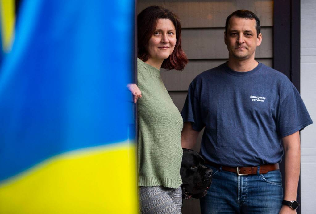 Marina and Mike Stiranka at their home with their dog Gus on March 17 in Edmonds. (Olivia Vanni / The Herald)
