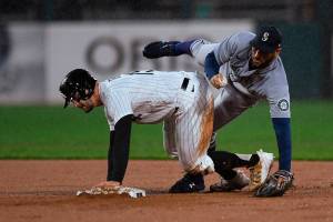 Seattle Mariners' Abraham Toro, right, collides with Chicago White Sox's Adam Engel after forcing him out at second base during the second inning of a baseball game Wednesday, April 13, 2022, in Chicago. Chicago won 6-4. (AP Photo/Paul Beaty)