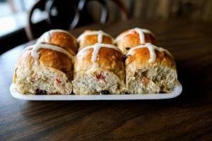 Oosterwyk’s Dutch Bakery's hot cross buns, filled with green and red cherries, currants and raisins are from Gerard Oosterwyk's signature recipe, according to his daughter and current owner Marja Oosterwyk. The bakery has been family-owned and run for 67 years and will celebrate its 101-year anniversary this summer. (Taylor Goebel / The Herald)