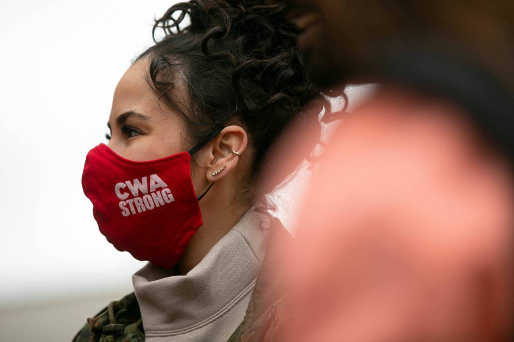 A woman wears pro-union clothing before a successful unionization vote Friday at a Verizon store in Everett. (Ryan Berry / The Herald)
