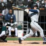 Seattle Mariners' Jarred Kelenic watches his two-run home run during the second inning of a baseball game against the Chicago White Sox Thursday, April 14, 2022, in Chicago. (AP Photo/Paul Beaty)