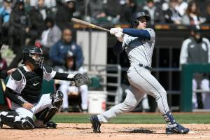 Seattle Mariners' Jarred Kelenic watches his two-run home run during the second inning of a baseball game against the Chicago White Sox Thursday, April 14, 2022, in Chicago. (AP Photo/Paul Beaty)