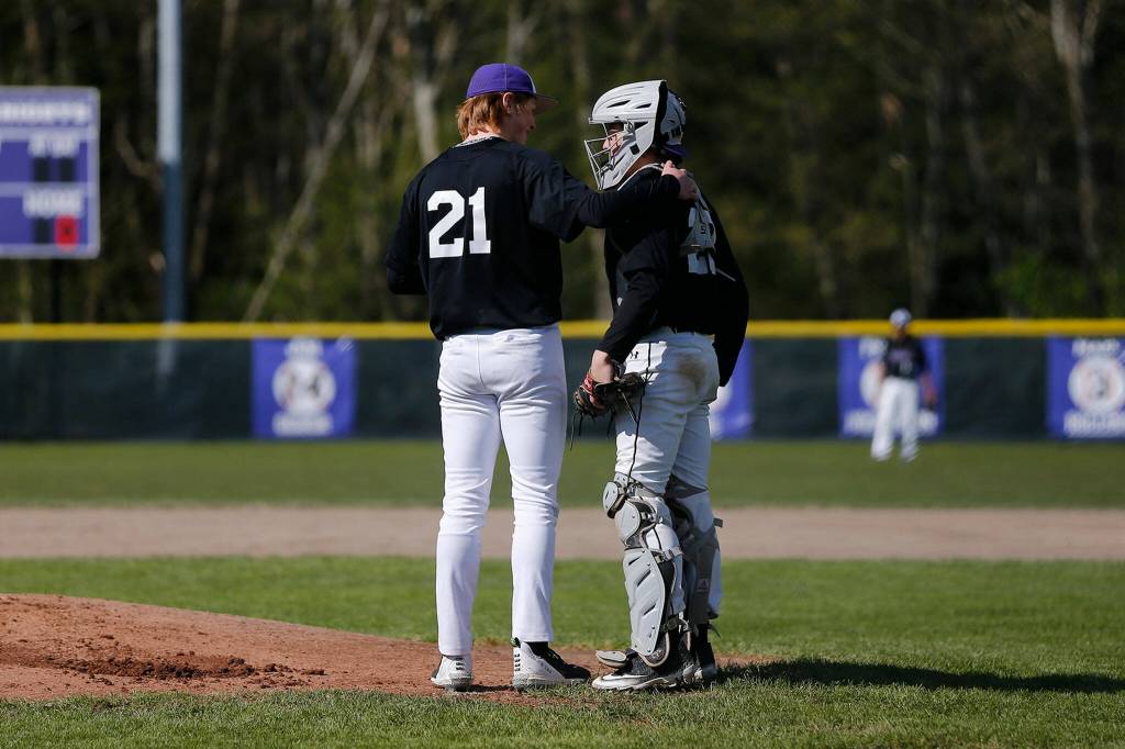 Kamiaks Atticus Manning and Jimmy Garmire talk at the mound during a tense first inning against Glacier Peak Friday, April 15, 2022, at Kamiak High School in Mukilteo, Washington. (Ryan Berry / The Herald)