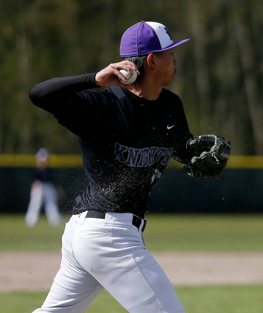 Kamiaks Thomas Lee makes the throw on a charging play at third base against Glacier Peak Friday, April 15, 2022, at Kamiak High School in Mukilteo, Washington. (Ryan Berry / The Herald)