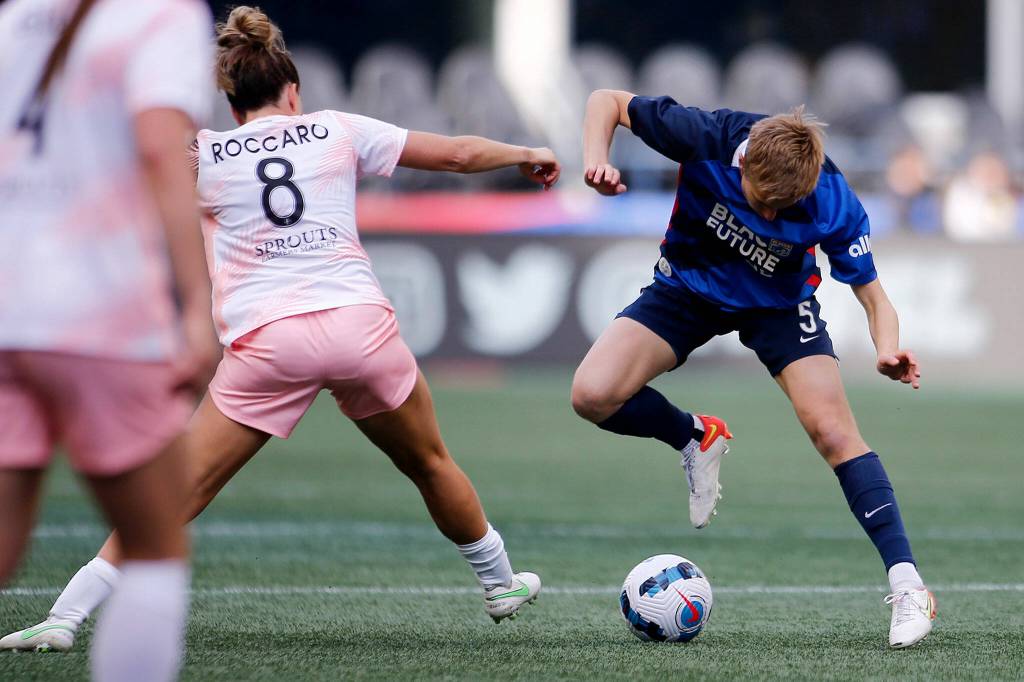 OL Reigns Quinn takes away possession of the ball during a NWSL Challenge Cup matchup against Angel City FC Sunday, April 17, 2022, at Lumen Field in Seattle, Washington. (Ryan Berry / The Herald)