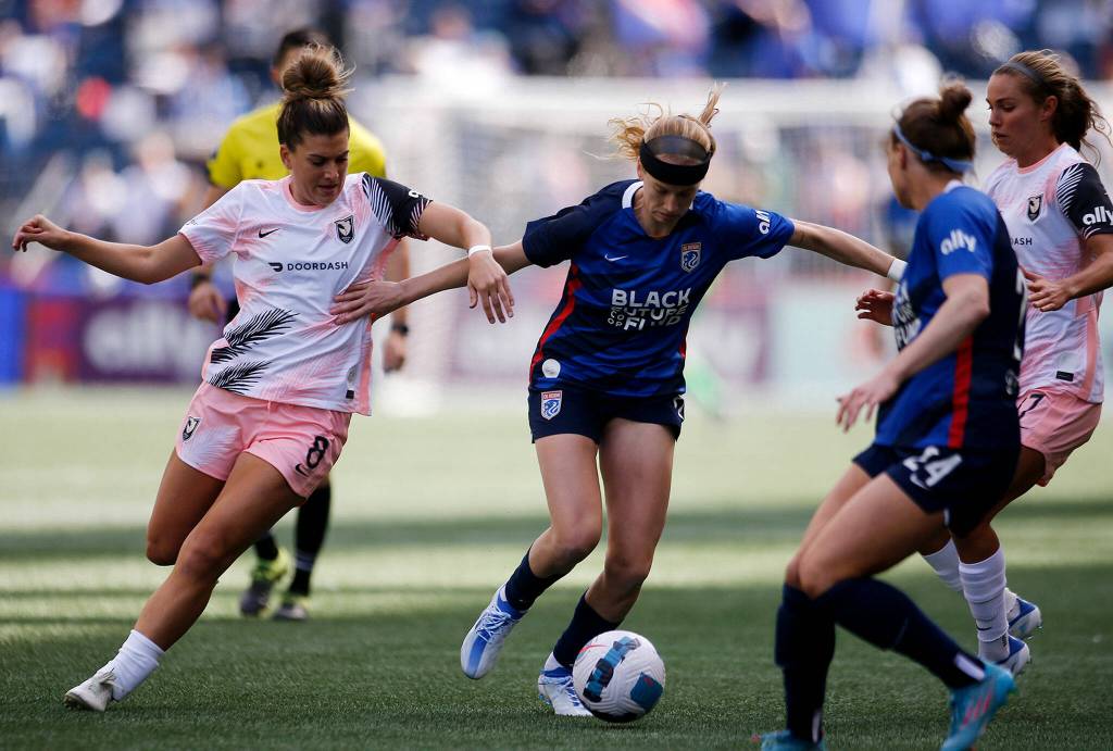 OL Reigns Bethany Balcer tries to maintain possession while taking the ball up the field during a NWSL Challenge Cup matchup against Angel City FC Sunday, April 17, 2022, at Lumen Field in Seattle, Washington. (Ryan Berry / The Herald)