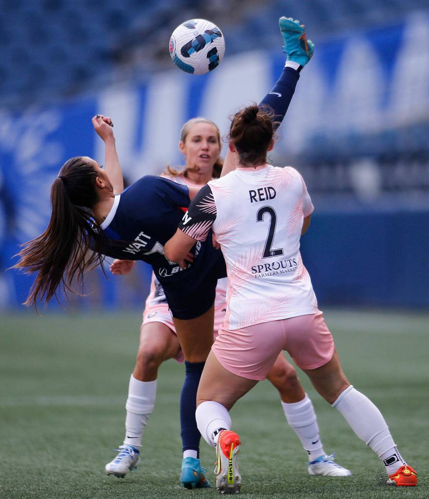 OL Reigns Ally Watt hits the ball over her own head while trying to gain possession during a NWSL Challenge Cup matchup against Angel City FC Sunday, April 17, 2022, at Lumen Field in Seattle, Washington. (Ryan Berry / The Herald)