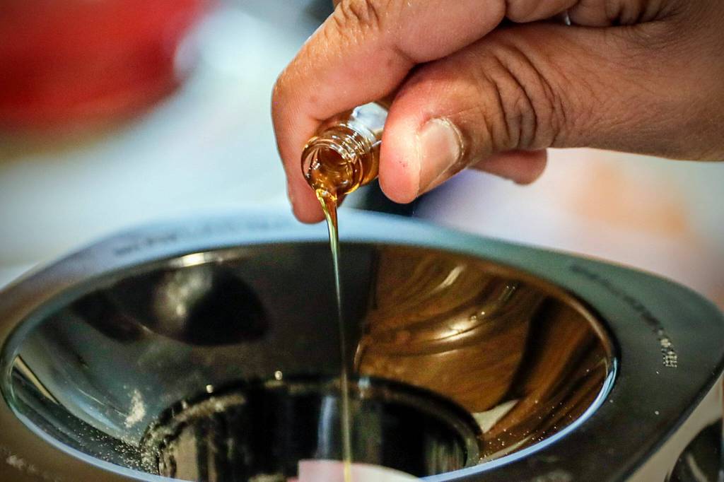 CBD is poured into a blender of cheesecake mix at the home of Charles Gill III in Everett. (Kevin Clark / The Herald)