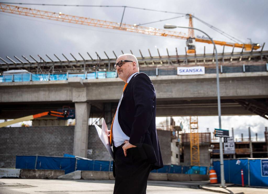 Community Transit CEO Ric Ilgenfritz in front of Lynnwood Link light rail construction Tuesday before a groundbreaking ceremony for the Swift Orange line. (Olivia Vanni / The Herald)