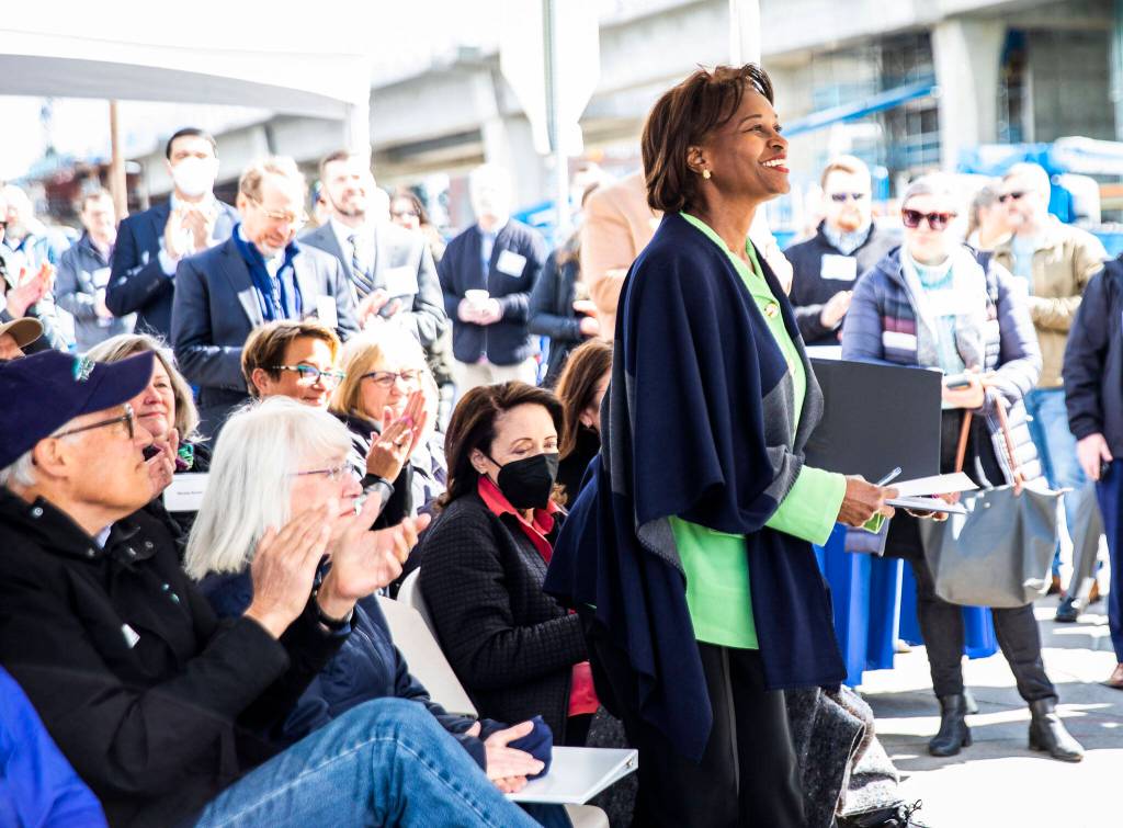 Federal Transit Administration Administrator Nuria Fernandez stands to speak at the groundbreaking ceremony for the Swift Orange bus rapid transit line Tuesday in Lynnwood. (Olivia Vanni / The Herald)