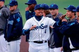 The AquaSox’s Noelvi Mart high-fives teammates during introductions before a game against Eugene Friday, April 8, 2022, at Funko Field in Everett, Washington. (Ryan Berry / The Herald)