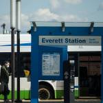 A man wearing a face mask walks toward the rear door of a Community Transit bus at the Everett Station on Friday, March 20, 2020 in Everett, Wa. (Olivia Vanni / The Herald)